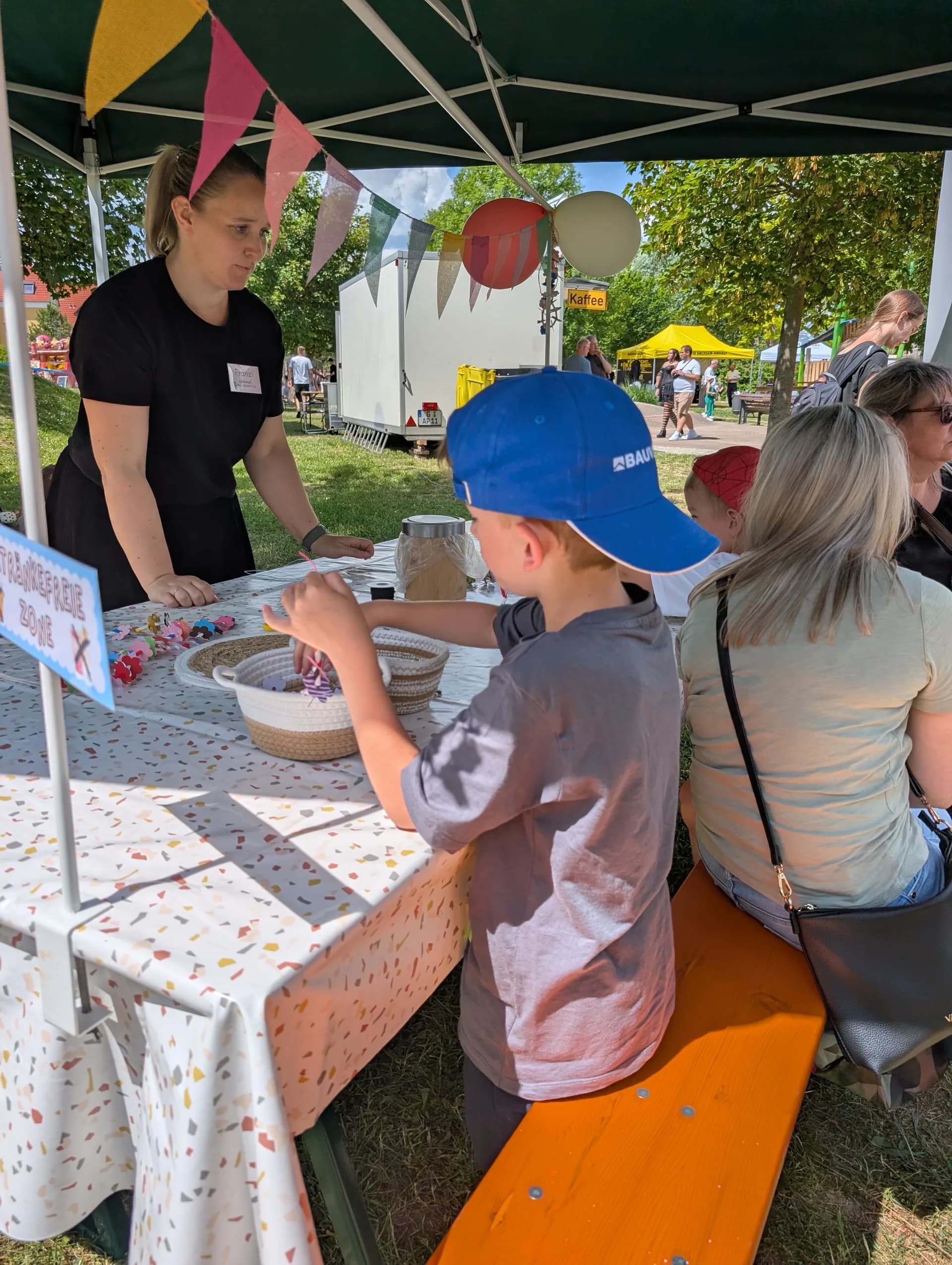 Mitarbeiterin Franzi der Erlebnisinsel hilft Kindern beim Basteln auf einem Event
